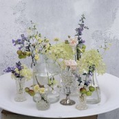 vintage sheer glasses and vases with various wildflowers will give a slight summer feel to the space and can fit both a vintage and a boho space