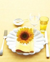 accentuate each place setting with a single bold bloom to give it a bright and cool summery feel
