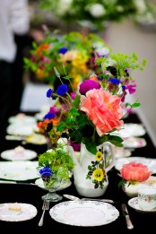 vintage painted teapots and glasses with super bright blooms and greenery are nice to accent any tablescape