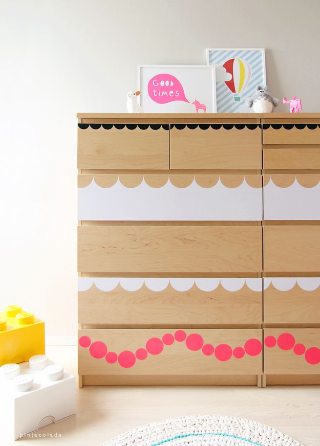 A light stained IKEA Malm dresser hacked with simple white and pink decals on the drawers