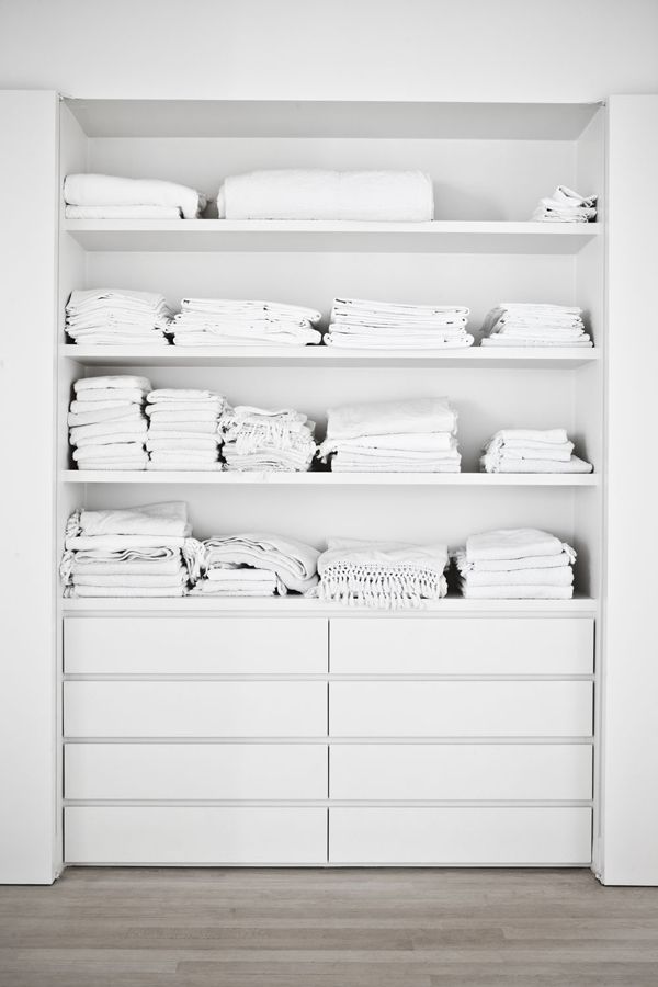 A built in closet with open shelving and IKEA Malm dressers for smaller items is a simple and cool idea