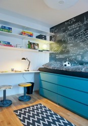 a kids’ bed placed on turquoise IKEA Malm dressers maximizes the storage space without cluttering the room