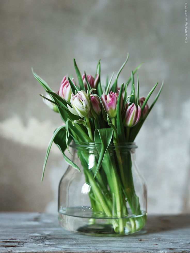 A large jar with pink tulips is a simple spring like decoration that can be made anytime