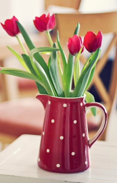 A red polka dot jg with red tulips is a simple and casual spring or Easter decoration to rock, it's a bit retro