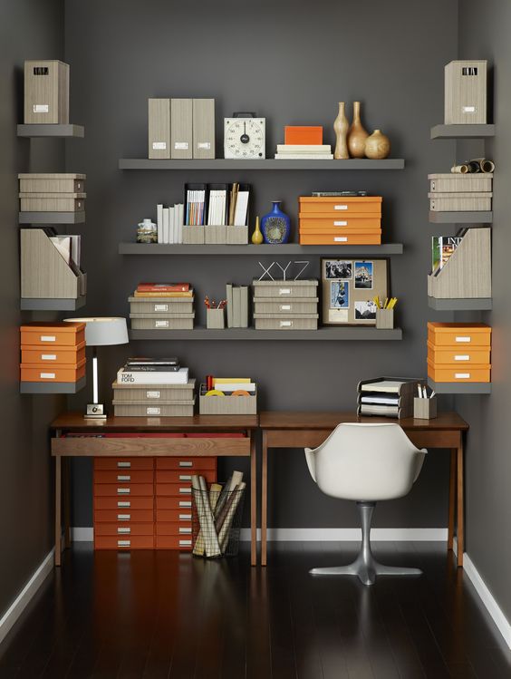 Open wall moutned shelves all around the desk will hold a lot of stuff without taking your desk space