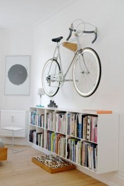 a wooden holder attached to the wall can hold your bike easily and can be attached in any room, it won’t spoil your space