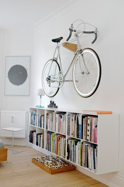 a wooden holder attached to the wall can hold your bike easily and can be attached in any room, it won't spoil your space
