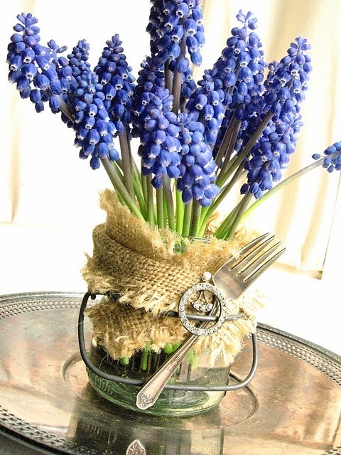 a jar with burlap, a fork with a brooch and bright purple hyacinths for a rustic and farmhouse spring centerpiece