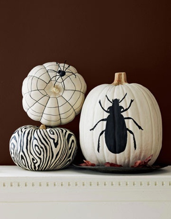 If you can't find white pumpkins, paint orange ones with several coats of white latex paint. Next, using a paint pen you can freehand-paint or stencil simple black designs on them.