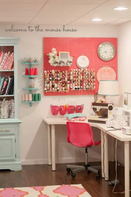 a coral pegboard with containers and hanging units with paint