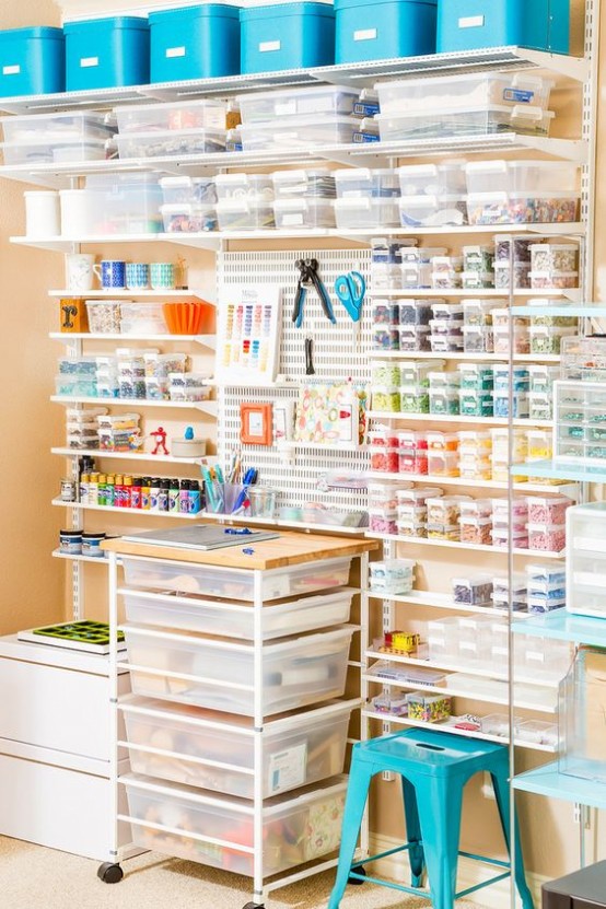 an oversized open shelving unit with little sheer containers with lids looks very neat and organized