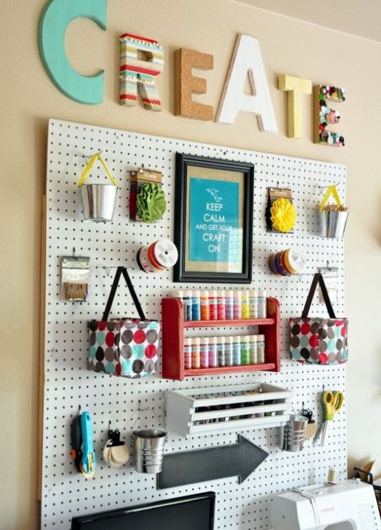 a pegboard with lots of shelves, ledges, buckets and even hanging bags