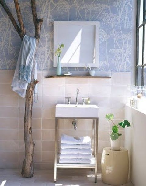 a driftwood piece as a hanger for clothes and towels in your bathroom