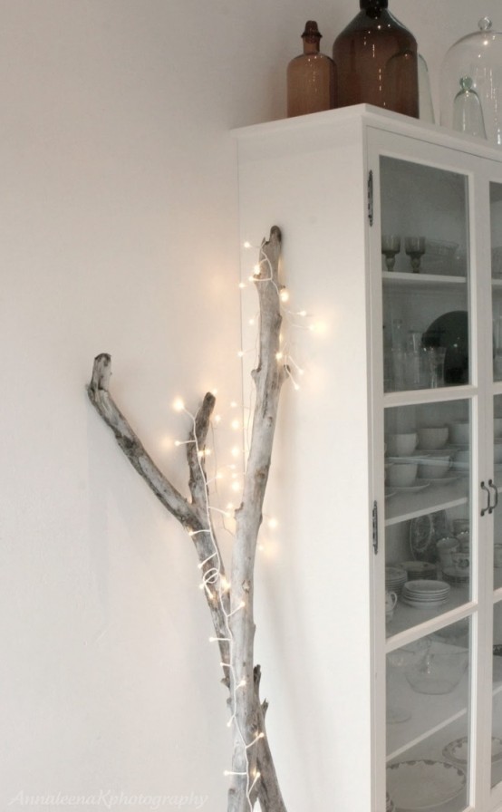 driftwood covered with lights is a cool idea for home decor