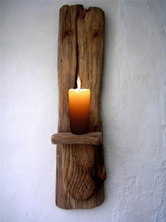 a drifwood wall holder with a candle for a beachy and breezy feel