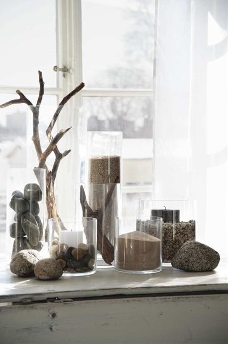 pebbles, sand and driftwood in glass jars will create a relaxed feel in your space 