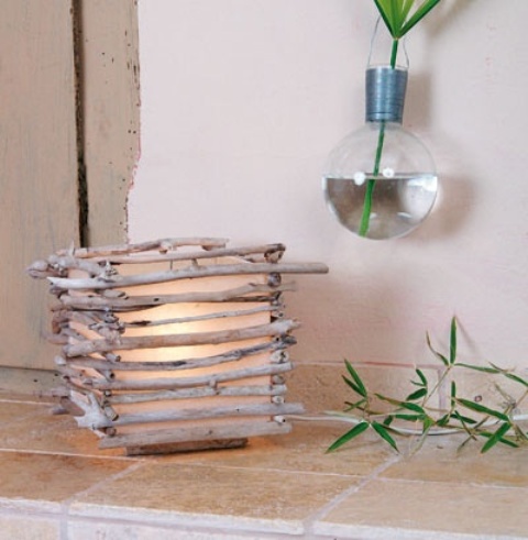 a candle holder clad with driftwood is a chic coastal DIY