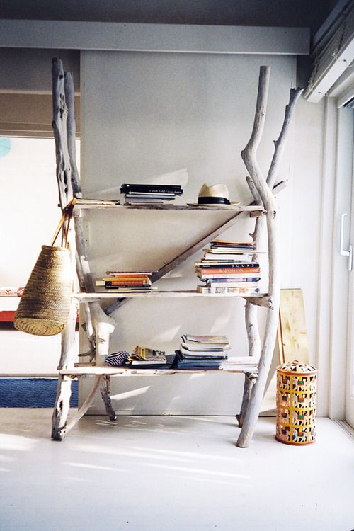 a large yet airy storage unit of shelves and driftwood is a gorgeous idea for a coastal home