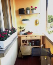a Forhoja cart used as a storage unit in a small balcony and as a plant stand at the same time, it’s very comfy in using
