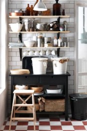 a black IKEA Forhoja cart used as kitchen furniture, it features much sotrage space and you can hang some shelves over it