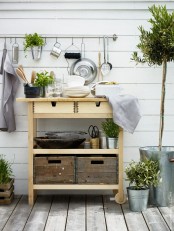 an Ikea Forhoja cart used for outdoors – for storing tableware, pots, planters, drinks and other stuff as a normal cart