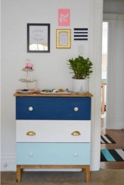 a bright Tarva hack in white, light blue and navy plus mismatching knobs, stained legs and a stained countertop