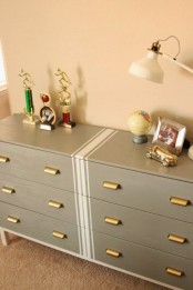 a grey Tarva hack with white stripes in the center and vintage brass knobs for a touch of elegance