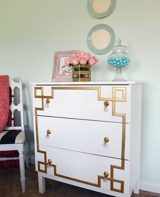 A vintage inspired Tarva dresser with gold inlays and gold and crystal pulls for a touch of art deco