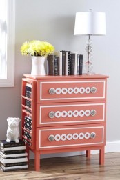 a coral Tarva hack with white inlays, glass knobs and a side magazine or book holder