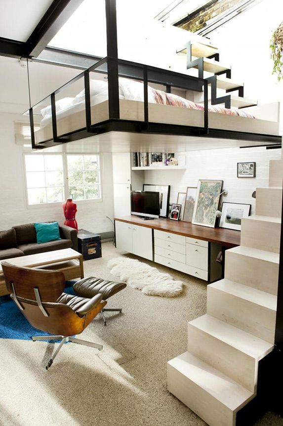 A mid century modern to Scandinavian space done in neutrals, black and with stained wood, a small loft bedroom and a ladder up
