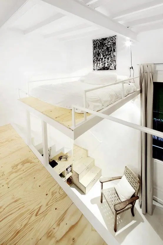 a creative floating loft bedroom that shows off just a bed with neutral bedding and some lights around
