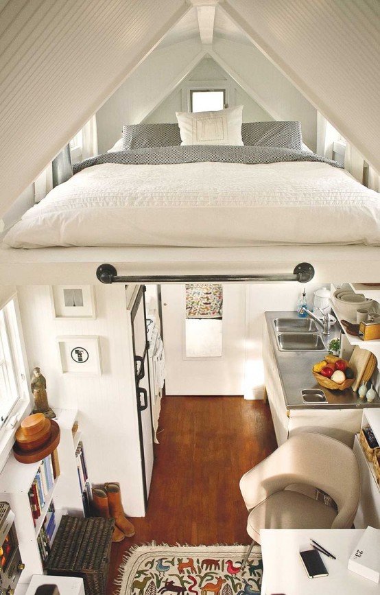 a small comfy space done in neutrals, with a loft bedroom that includes only a low bed and some skylights but still allows sleeping comfortably