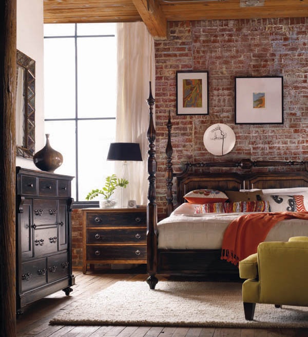 A vintage meets mid century modern bedroom is made edgy and more harsh with an exposed brick wall