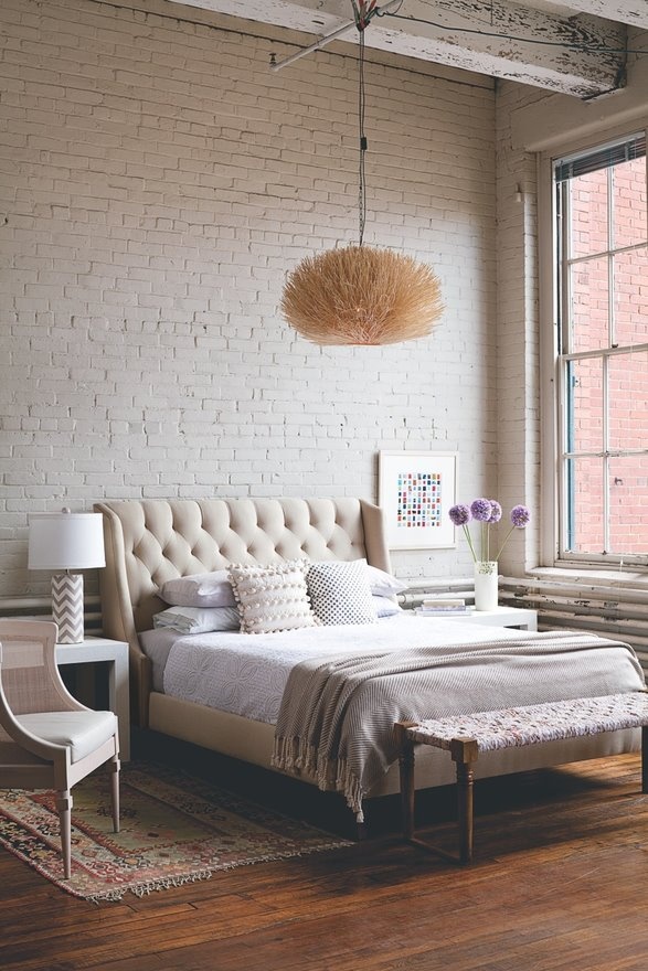 A cute girlish bedroom with a vintage feel features a white brick statement wall that adds a harsh and edgy touch to the area