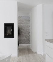 a very laconic Nordic space made interesting and catchier with a whitewashed brick wall as an accent, it brings texture