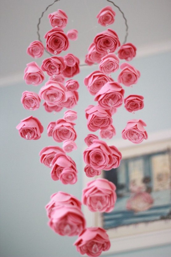 a gorgeous pink fabric rose mobile for a nursery, with beads and pearls is a beautiful solution for a flower-infused space