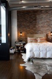 a stylish bedroom with a brick wall