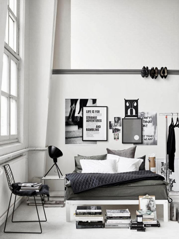 a Scandinavian bedroom with industrial touches - a metal shoes holder on the wall, a makeshift closet and some blackened metal touches