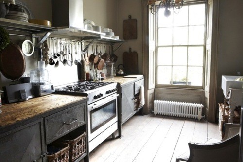 Railing for kitchen utensils and copper pots is more than welcome on a smart industrial kitchen.