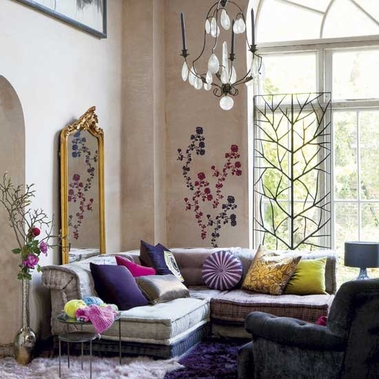 Wall decals is an unusual but more than welcome addition to a boho decor. The cool thing in this room is that flowers on a wall reflects in a vintage mirror.