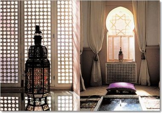 a neutral Moroccan bathroom with a catchy window shutter, curtains, a purple pillow and sunken bathtub