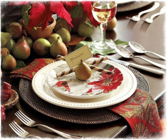 a rustic Christmas tablescape with woven chargers, printed napkins, potted blooms and pears