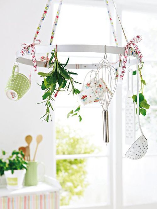 a kitchen chandelier with cutlery, mugs, floral print ribbons and bows is a cool spring decoration