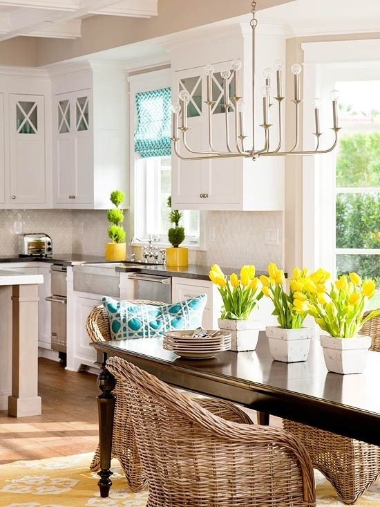 a blue and white pillow and bright yellow tulips and greenery are an easy idea to spruce up your kitchen decor