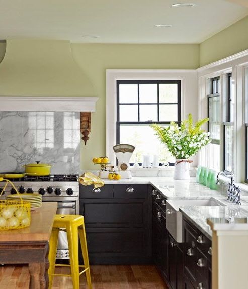 Bright yellow items, lemons and cookware make the kitchen feel spring like and yellow blooms echo with them all