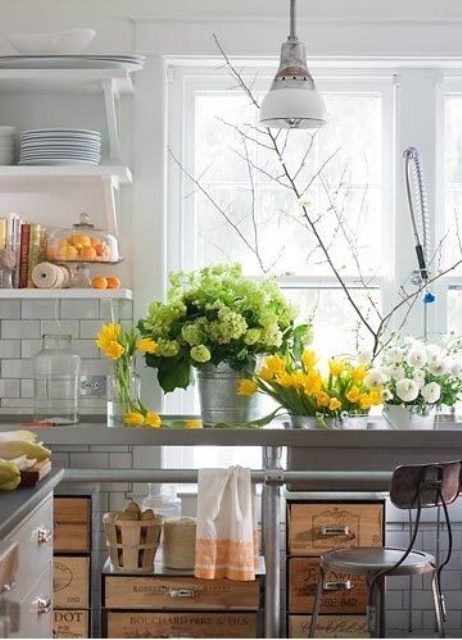 Fresh blooms in green, white and yellow and greenery make the kitchen feel more spring like, bold and fun