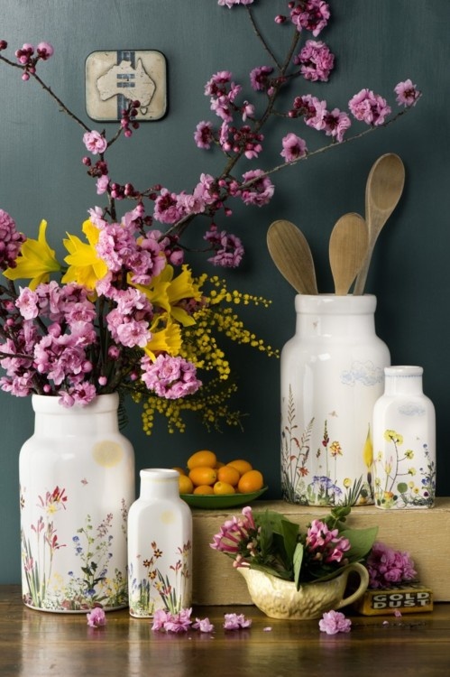 Pink cherry blossom, bright yellow blooms and floral print vases make the kitchen feel fresh and spring like