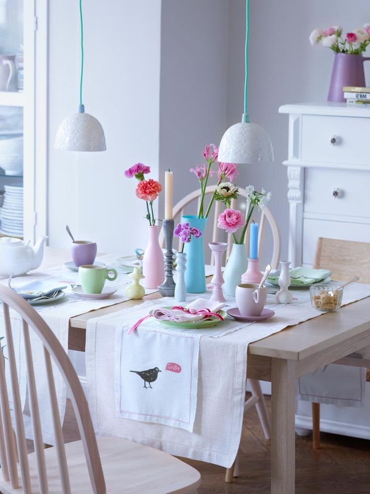 Pastel tableware, bright blooms and pastel napkins make the kitchen feel more spring like