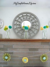 colorful pompom arrangements in jars, a bright paper garland for spring