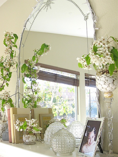 Lots of blooming branches and a large mirror   you won't need more to create a chic mantel for spring